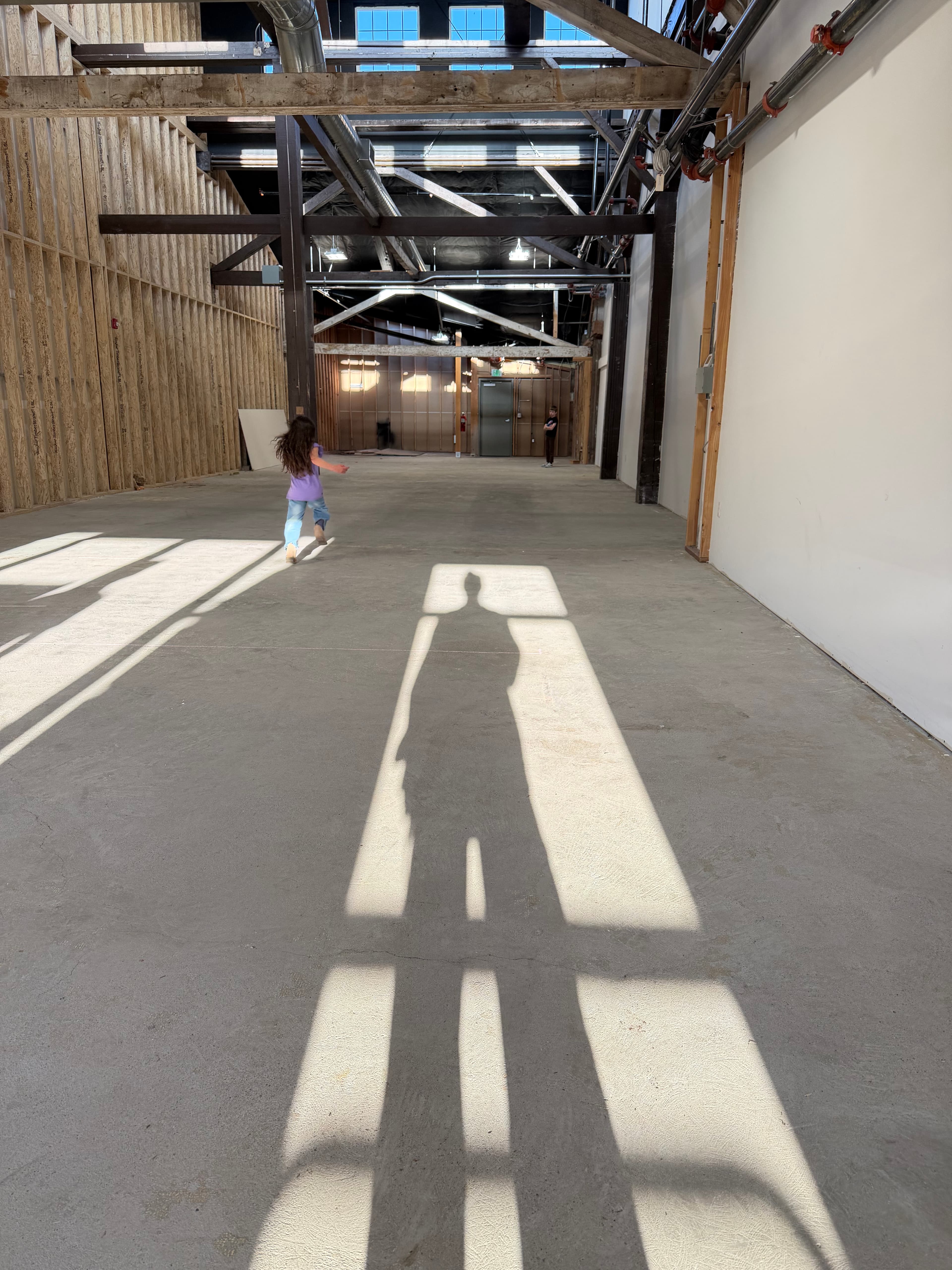 Child running through the Bend The Mic space with dramatic shadow