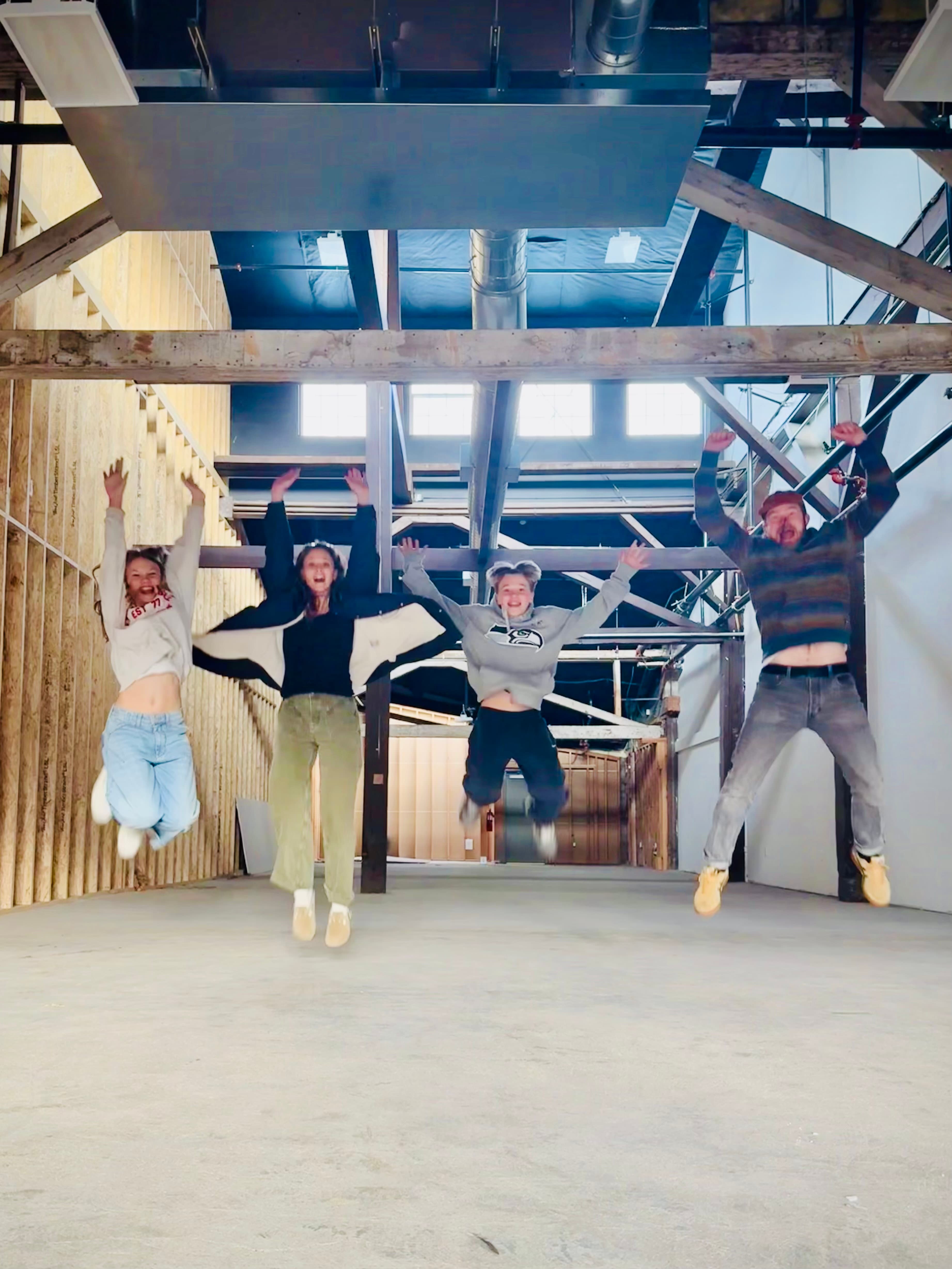 Myers family jumping in the Bend The Mic space