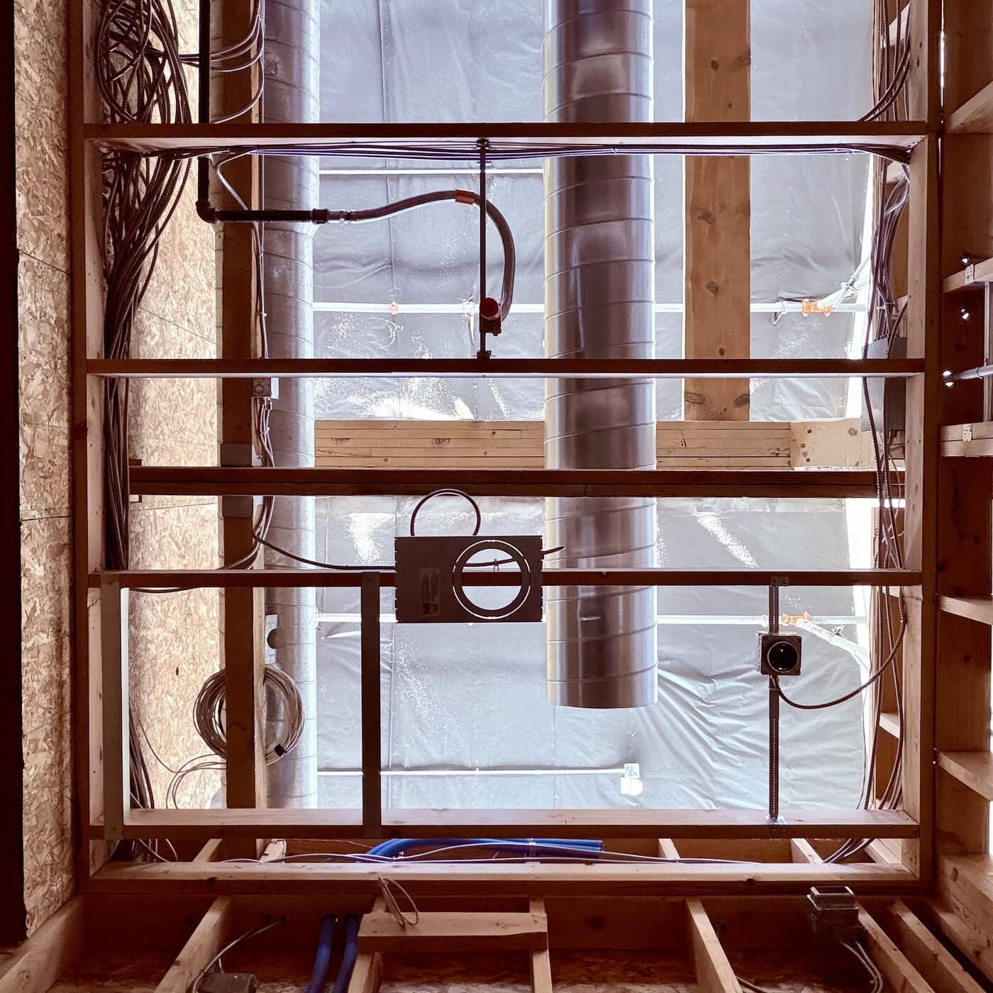 Ducting, conduit and wiring framed into an open wall