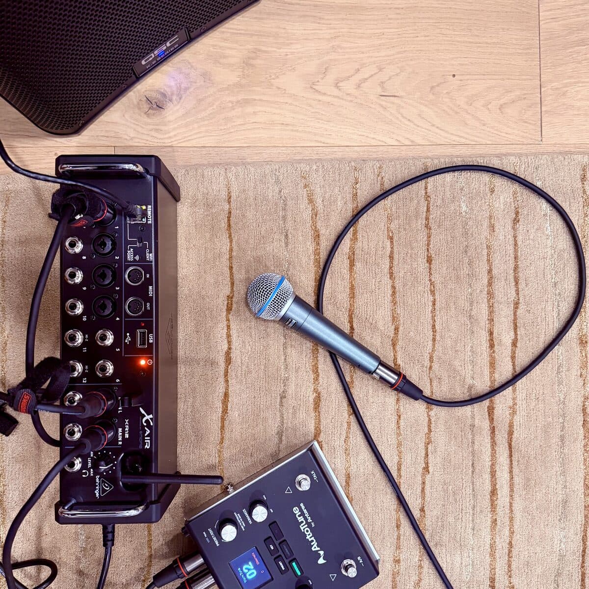 A microphone and a small mixing desk on the new wood floor
